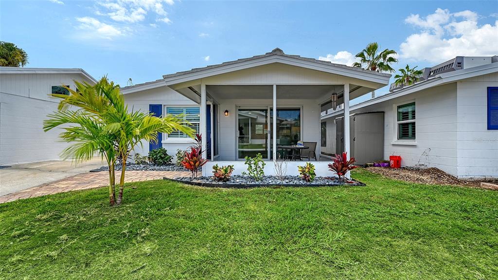 6020 Midnight Pass Road, Unit 63 Sarasota, FL 34242 - Photo 20 of 52 a view of a house with backyard porch and sitting area