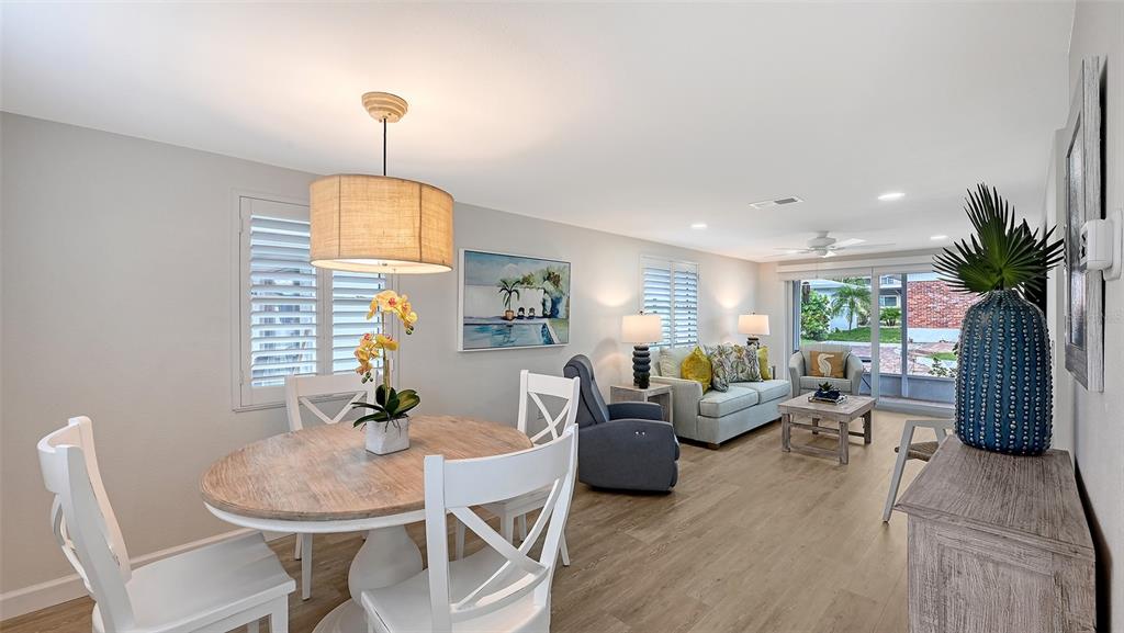 6020 Midnight Pass Road, Unit 63 Sarasota, FL 34242 - Photo 5 of 52 a view of a dining room with furniture window and wooden floor