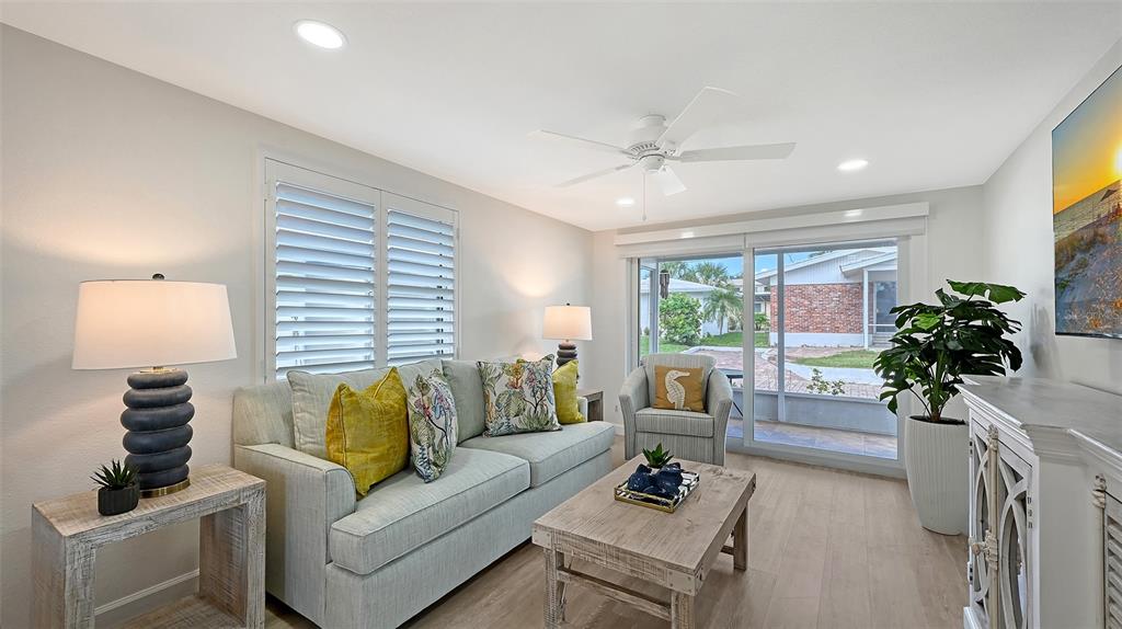 6020 Midnight Pass Road, Unit 63 Sarasota, FL 34242 - Photo 7 of 52 a living room with furniture and a potted plant