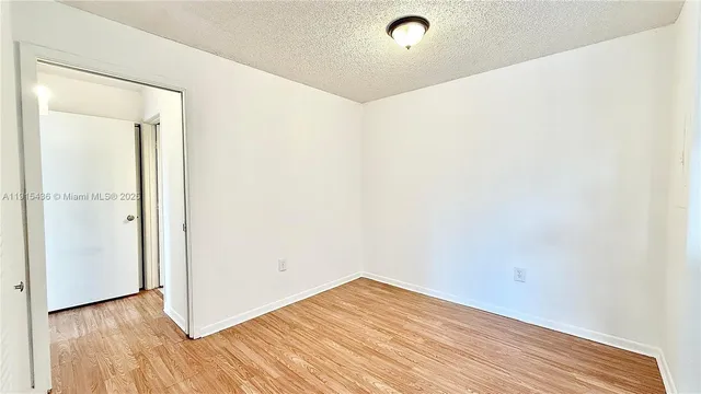 a kitchen with stainless steel appliances granite countertop a stove a refrigerator and a white cabinets
