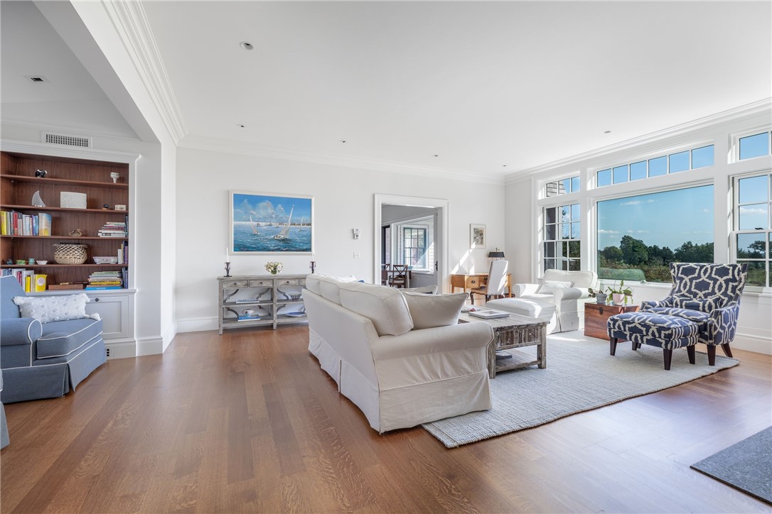 415 Poppasquash Road Bristol, RI 02809 - Photo 15 of 50 Living room with additional seating area off to the left and the kitchen is off in the distance.