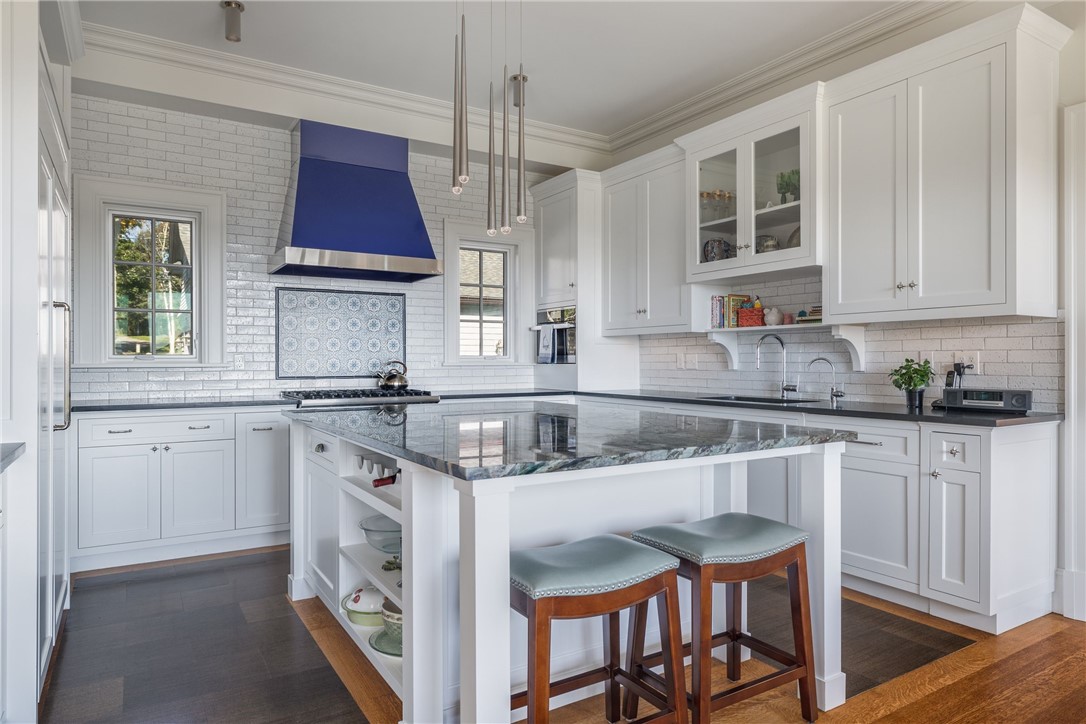 415 Poppasquash Road Bristol, RI 02809 - Photo 18 of 50 The first level eat-in-kitchen is equipped with Sub-zero, Viking and Miele appliances, rare stone counter-top, custom cabinets, and oak floors with a cork inlet for comfort while cooking.