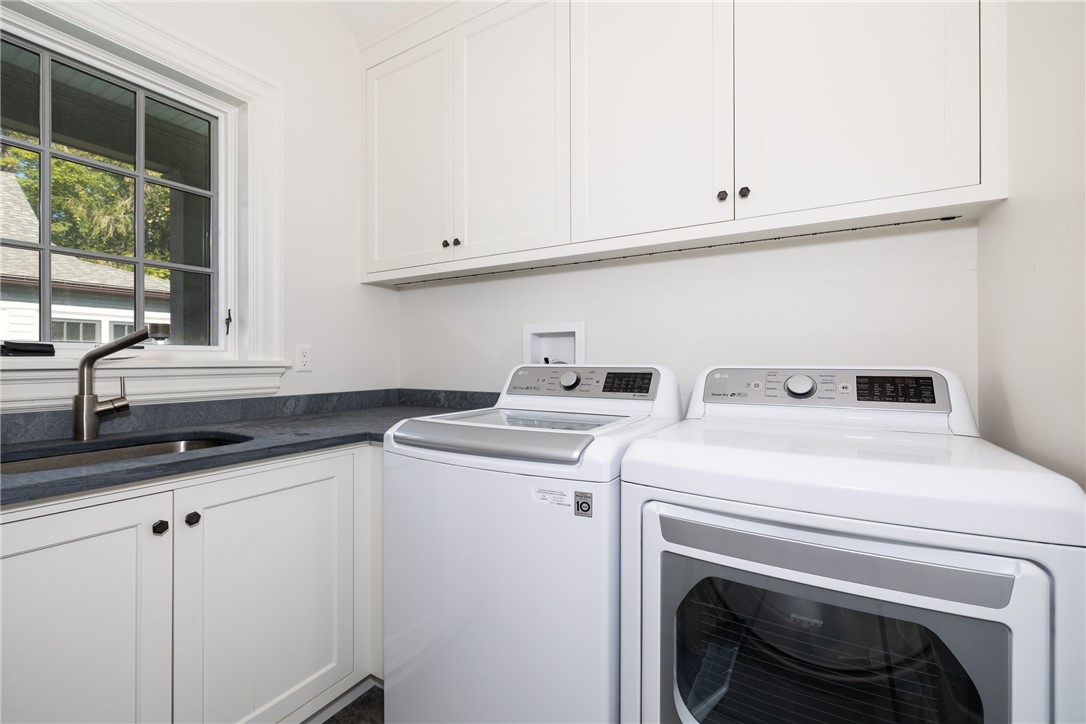 415 Poppasquash Road Bristol, RI 02809 - Photo 30 of 50 First floor laundry with plenty of storage is located off the mudroom for convenience.