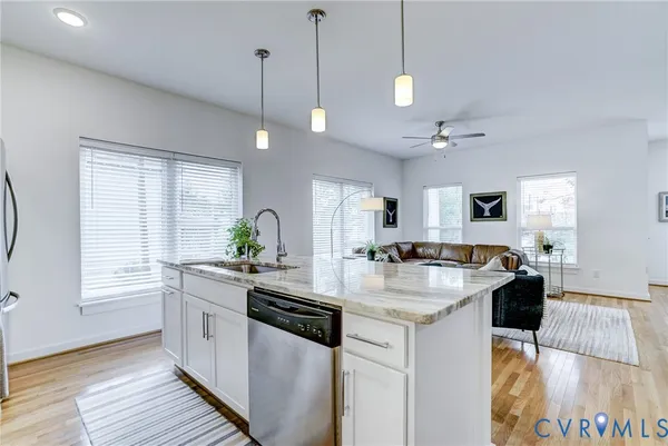 a kitchen with a stove a counter space a sink and cabinets
