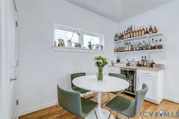 a dining room with furniture and wooden floor