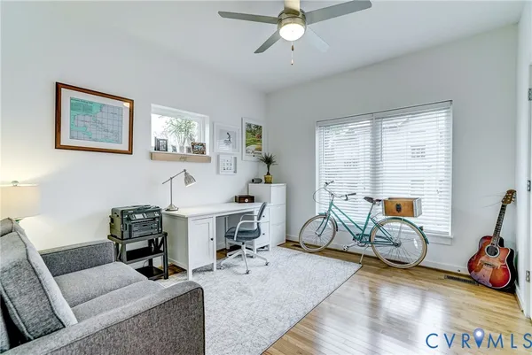 a view of a livingroom with workspace and a window