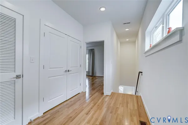 a view of a room with wooden floor and stairs
