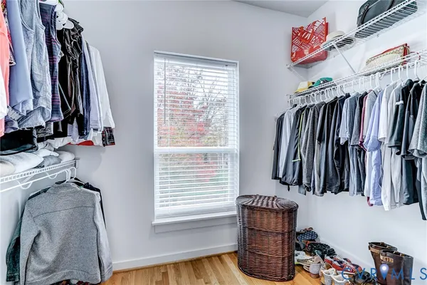 a view of walk in closet with clothes and shoes