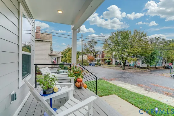 a view of a porch with furniture and a yard