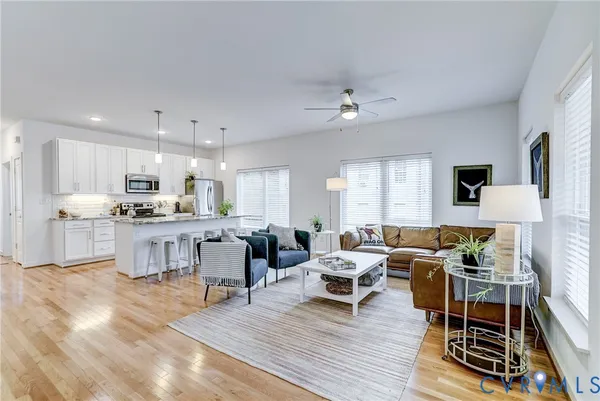 a living room with furniture and kitchen view
