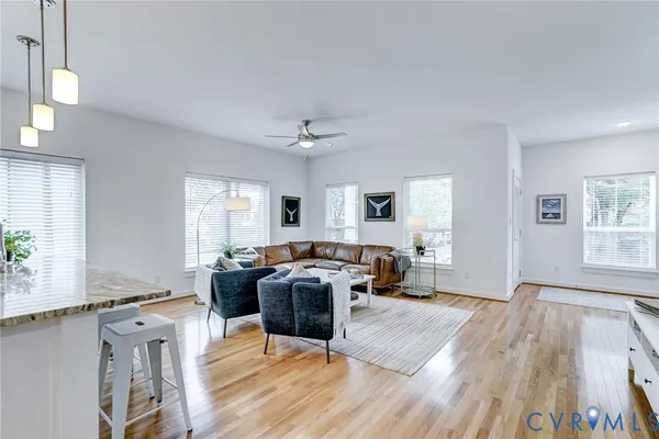 a living room with furniture window and wooden floor