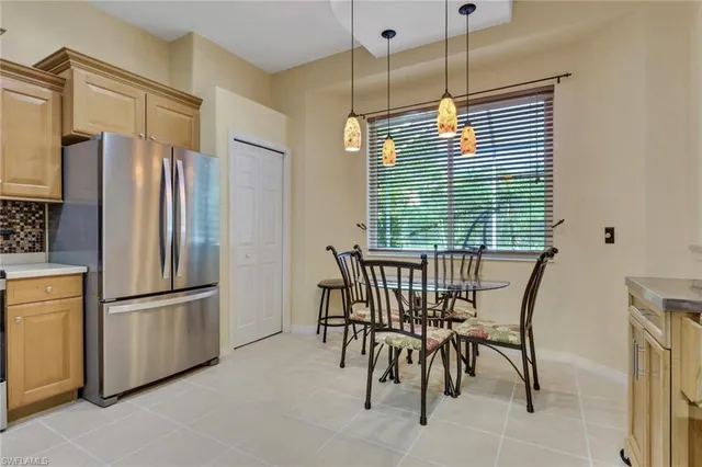 a kitchen with stainless steel appliances granite countertop furniture a refrigerator and a window