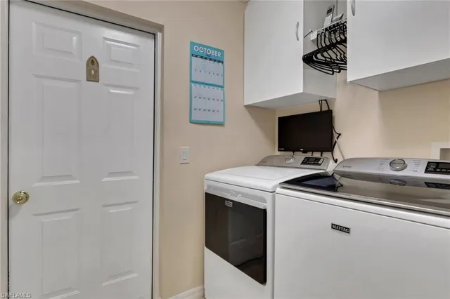 a kitchen with a sink and a washer dryer