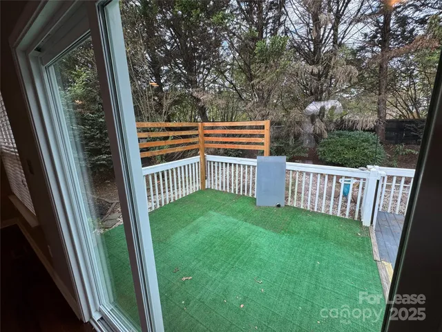 a view of backyard with deck and wooden floor