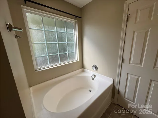 a bathroom with a sink a mirror a vanity and a bathtub