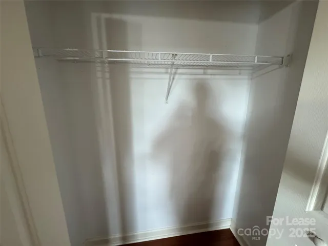 a view of a livingroom with wooden floor and a ceiling fan