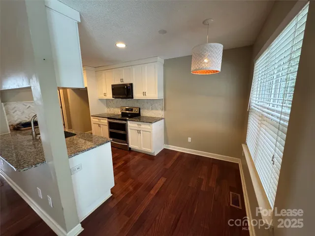 a kitchen with a sink and a stove top oven