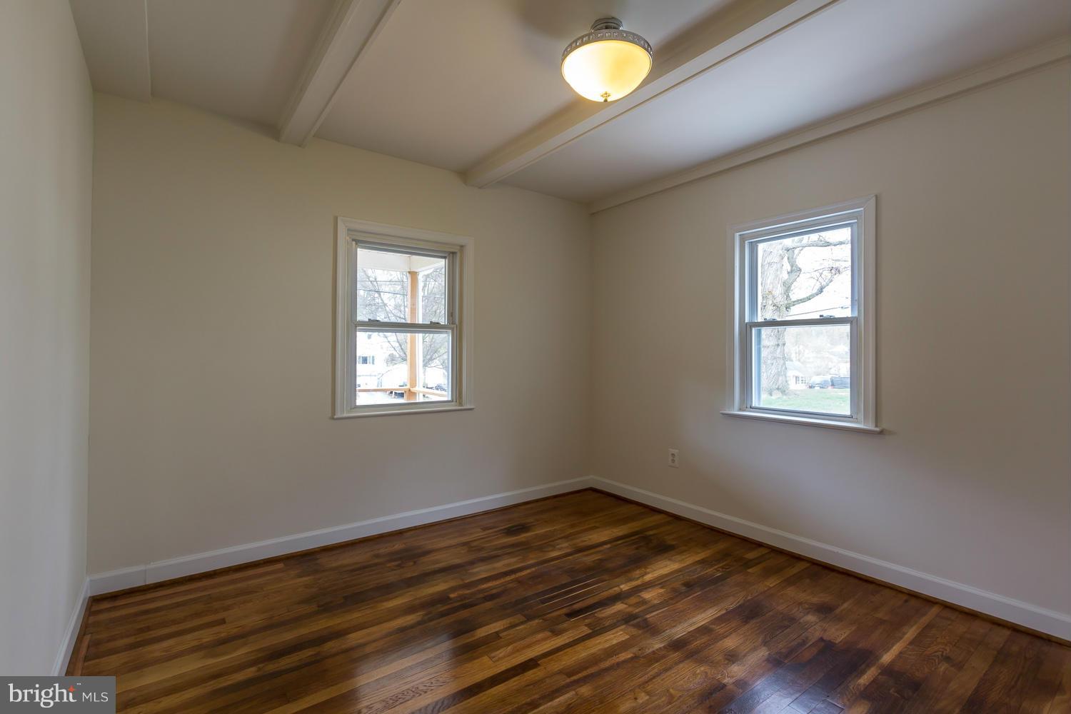 4503 Mahan Road Silver Spring, MD 20906 - Photo 14 of 25 a view of an empty room with wooden floor and a window