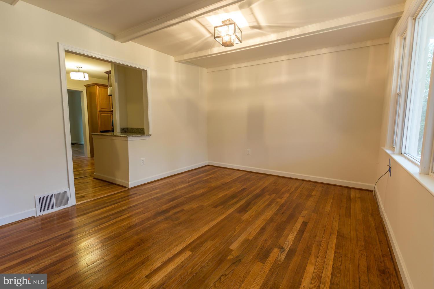 4503 Mahan Road Silver Spring, MD 20906 - Photo 3 of 25 a view of an empty room with wooden floor and a window