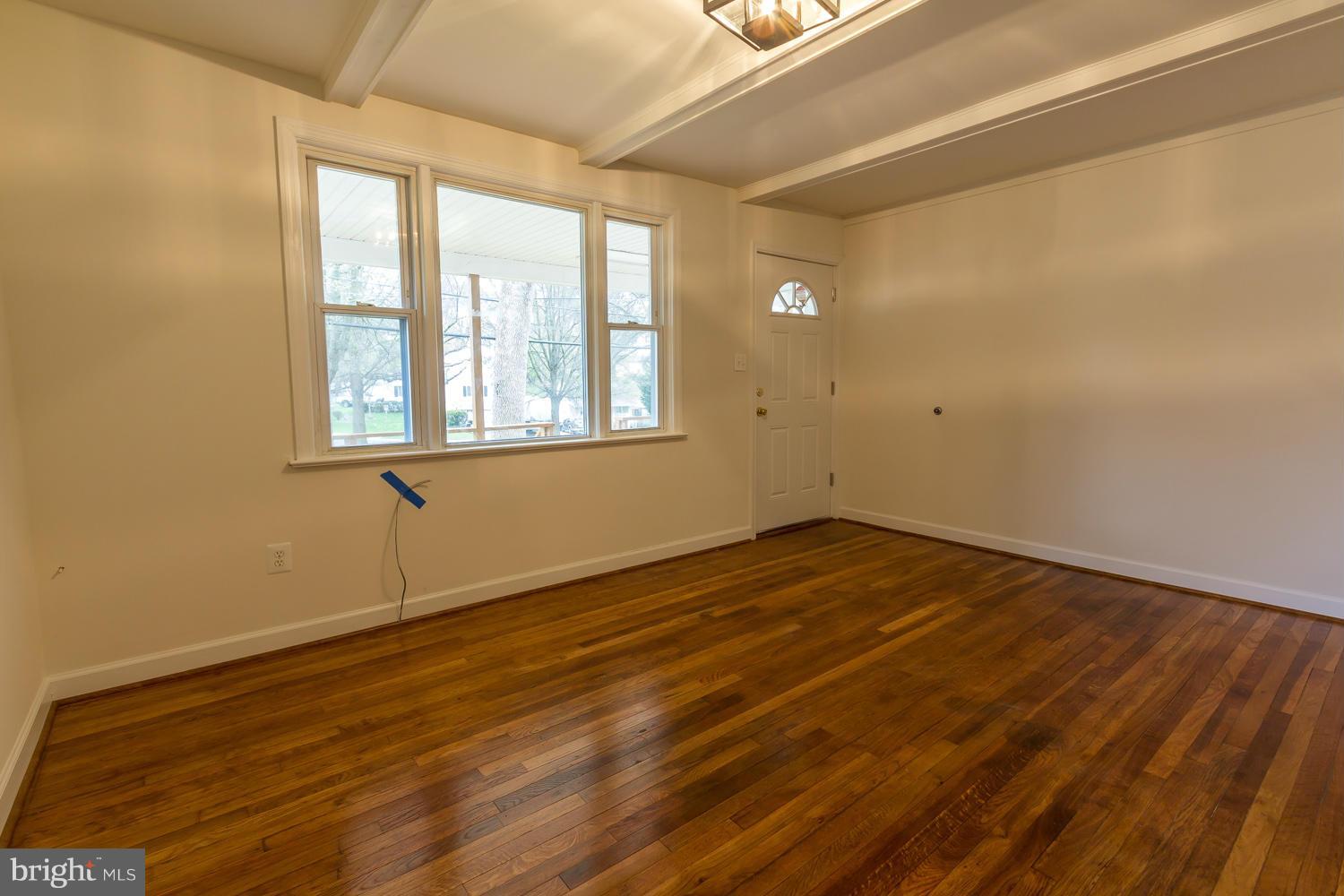 4503 Mahan Road Silver Spring, MD 20906 - Photo 5 of 25 a view of an empty room with wooden floor and a window