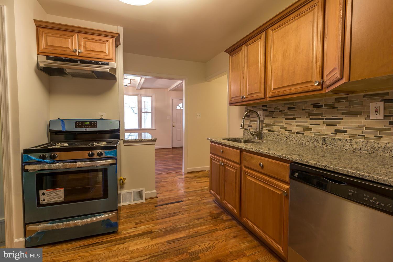 4503 Mahan Road Silver Spring, MD 20906 - Photo 6 of 25 a kitchen with stainless steel appliances granite countertop a stove a sink and a microwave