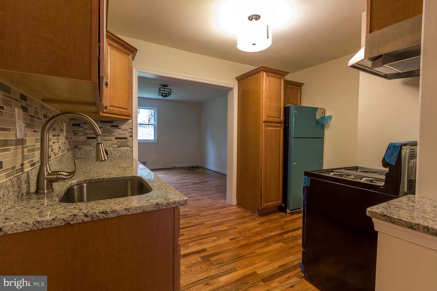 4503 Mahan Road Silver Spring, MD 20906 - Photo 7 of 25 a kitchen with granite countertop a refrigerator and a sink
