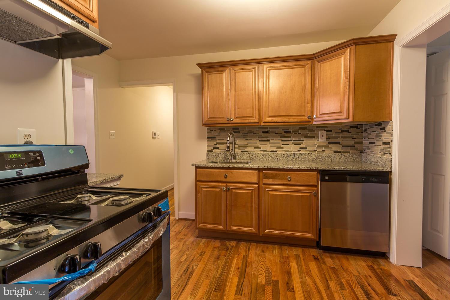 4503 Mahan Road Silver Spring, MD 20906 - Photo 8 of 25 a kitchen with wooden floors and a sink
