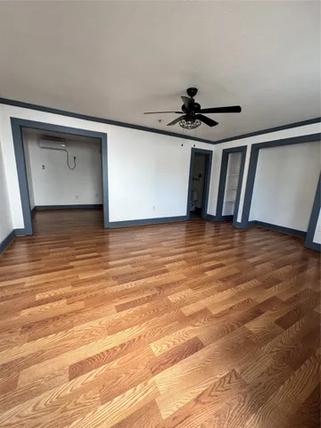 a view of a room with wooden floor