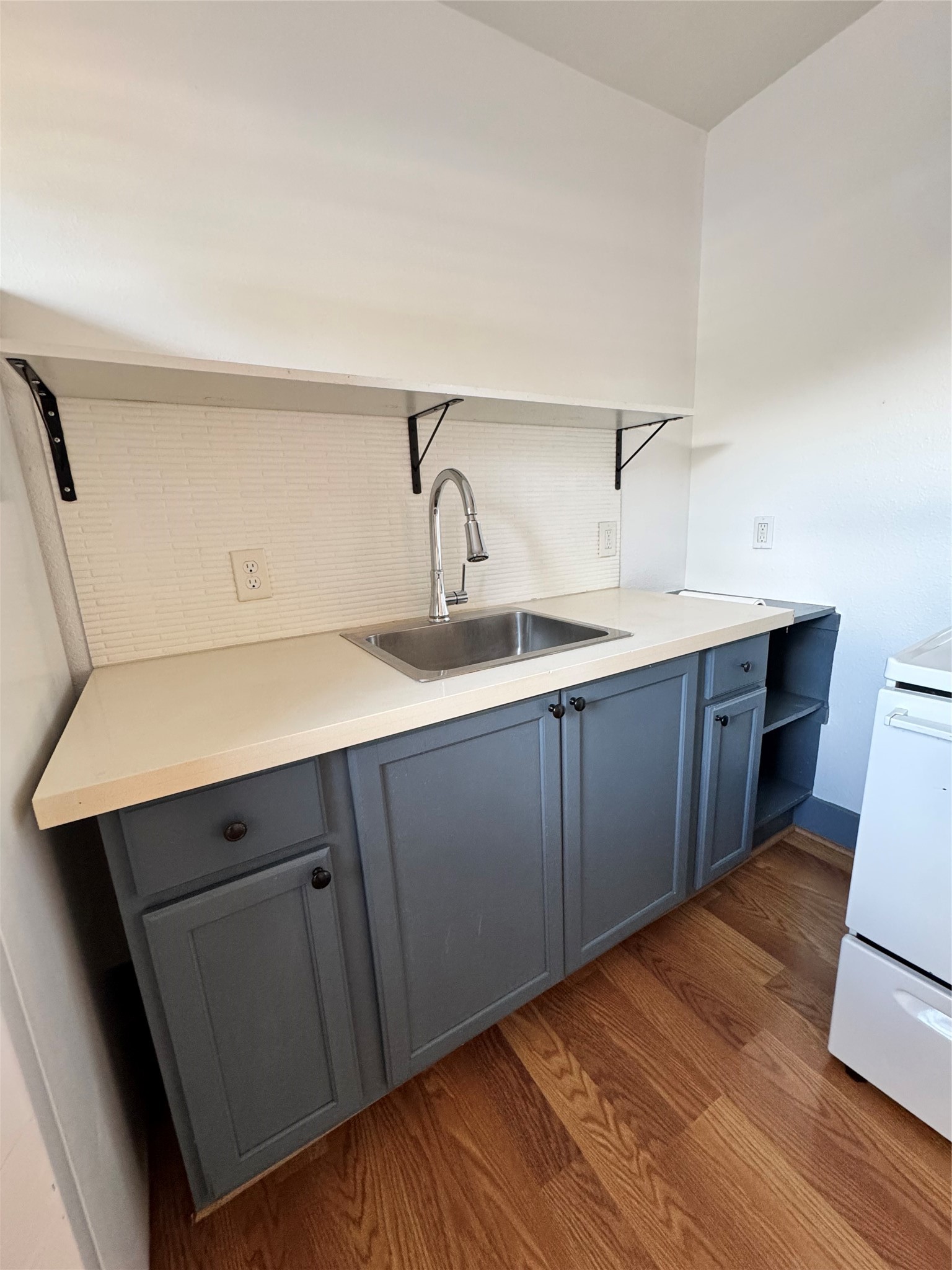 5304 Polk Street, Unit 1 Houston, TX 77023 - Photo 6 of 11 White quartz countertops with expose open shelving for storage.