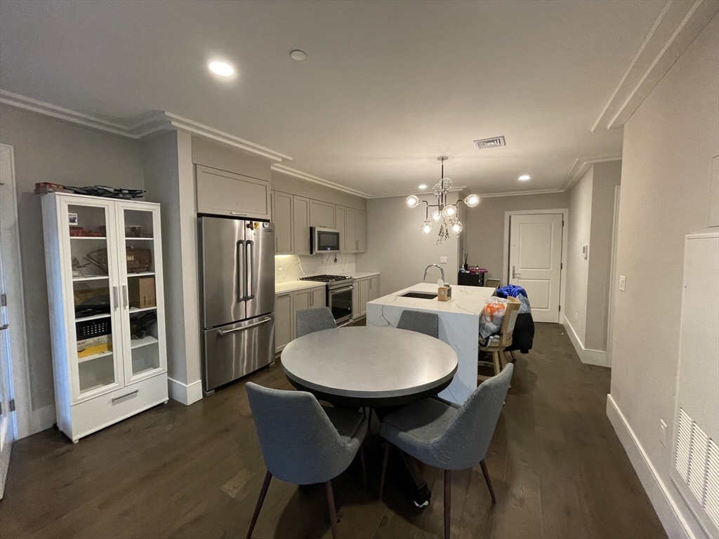 214 Market Street, Unit 301 Boston, MA 02135 - Photo 4 of 11 a large kitchen with a table and chairs