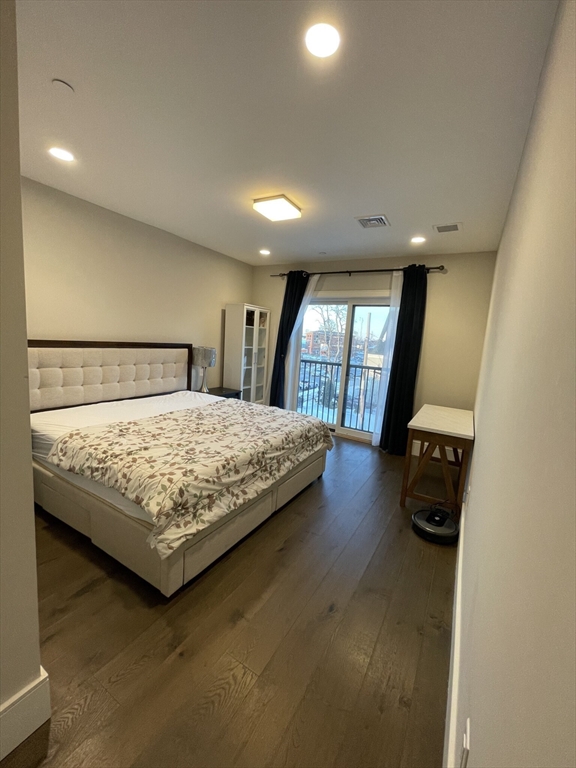 214 Market Street, Unit 301 Boston, MA 02135 - Photo 8 of 11 a bedroom with a large bed and a large window