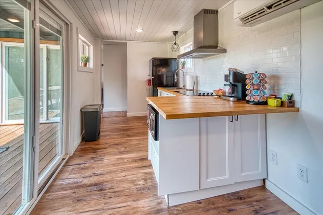 a kitchen with stainless steel appliances granite countertop a sink and wooden cabinets