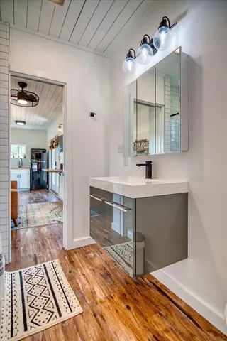 a kitchen with cabinets and wooden floor