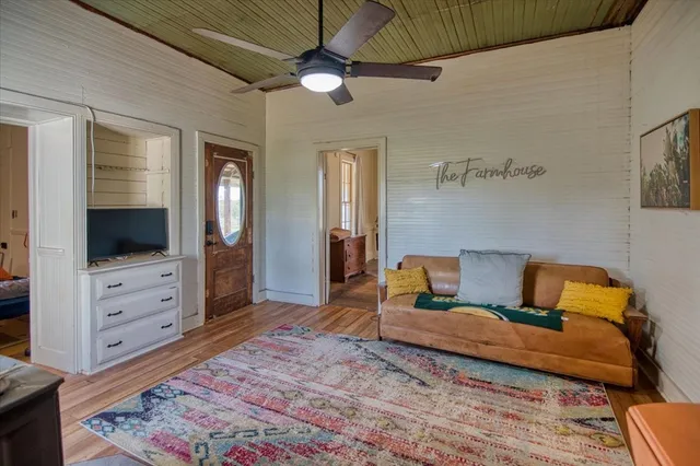 a bedroom with furniture and a flat screen tv