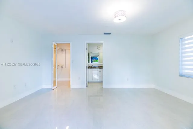 a bathroom with a granite countertop sink mirror and shower