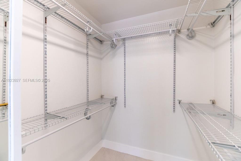 3425 Southwest 69th Avenue Miami, FL 33155 - Photo 32 of 40 a bathroom with a granite countertop sink mirror and shower