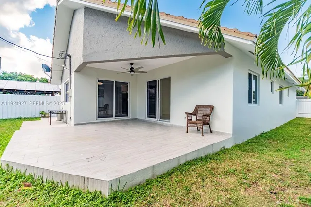 a front view of house with yard and trees