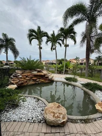 a view of a swimming pool with a table and chairs