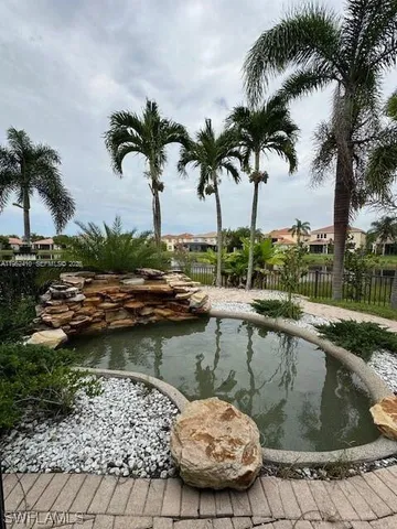 a view of a swimming pool with a table and chairs