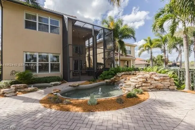 a view of a house with backyard and sitting area