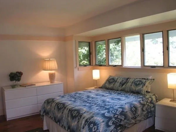 a bedroom with a large bed and a window