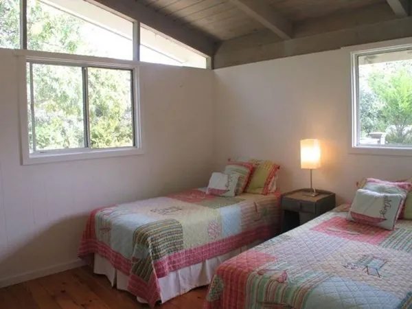 a bedroom with two beds and a window