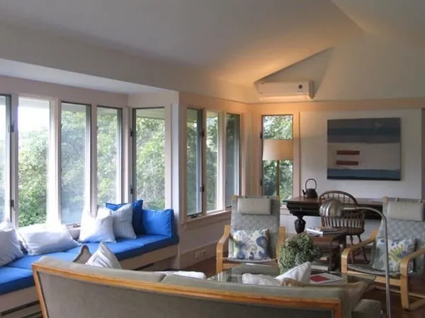 a living room with furniture and large windows