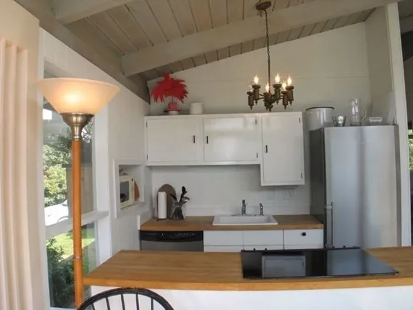 a kitchen with stainless steel appliances granite countertop a sink refrigerator and cabinets