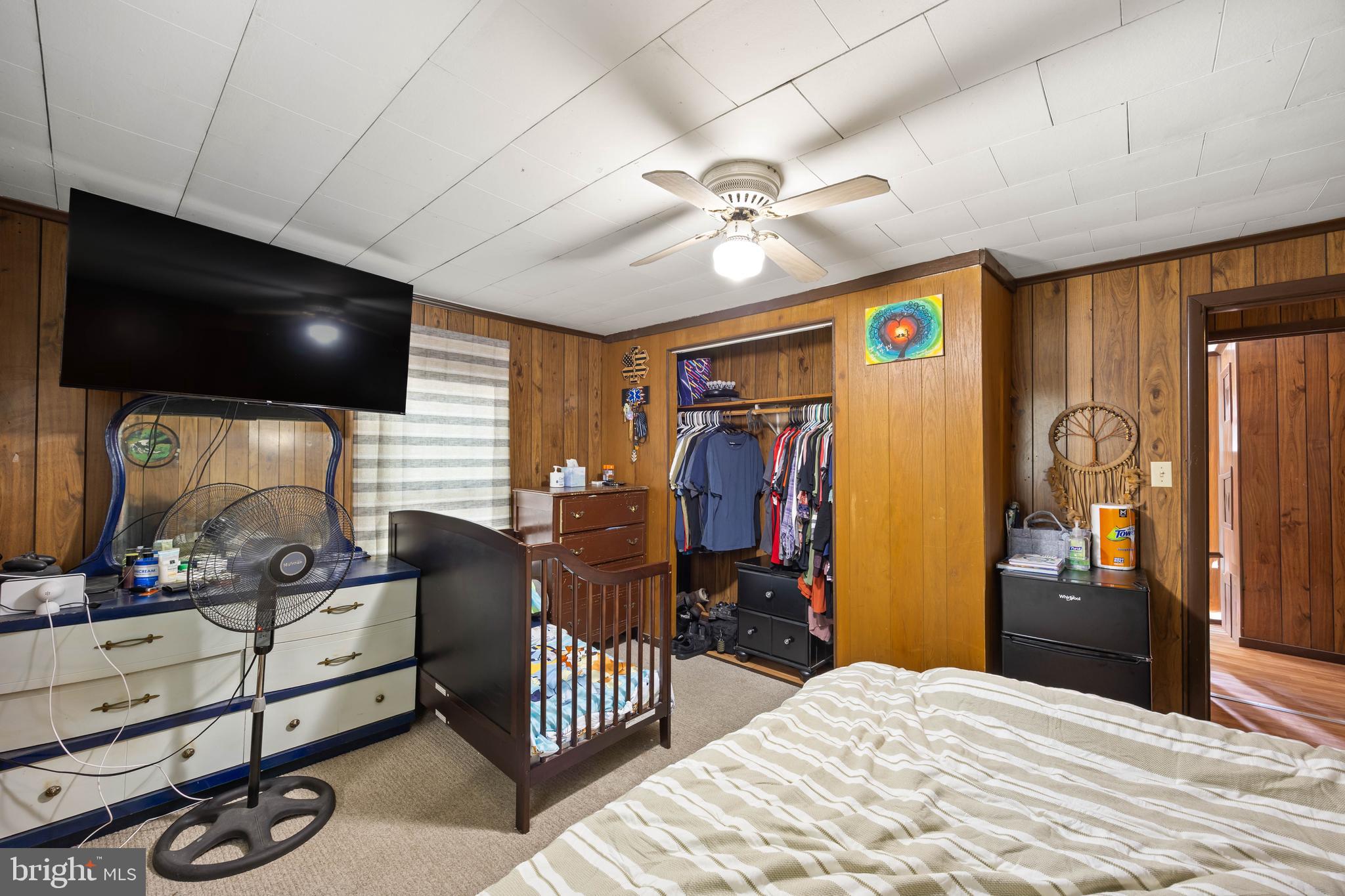 26467 Mariners Road Crisfield, MD 21817 - Photo 39 of 44 a bedroom with furniture and a flat screen tv
