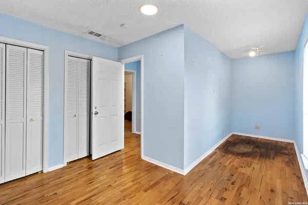 a view of a room with wooden floor and a sink