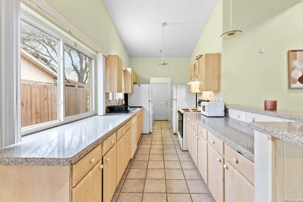a large kitchen with a large window