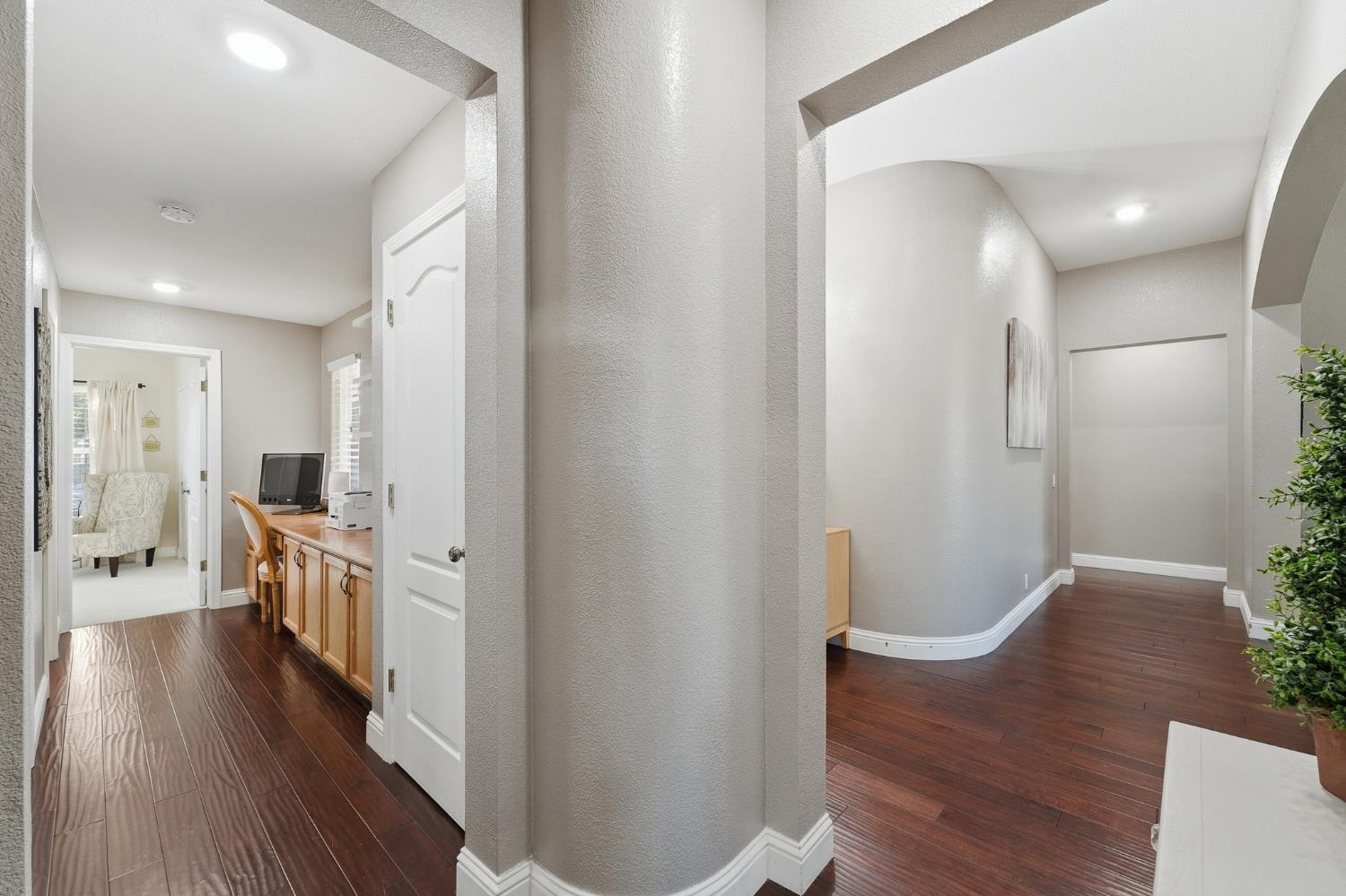 2220 Ellison Drive Modesto, CA 95355 - Photo 32 of 53 a view of a hallway with wooden floor and furniture