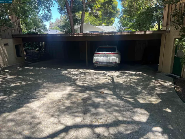 a view of a chair and table in backyard