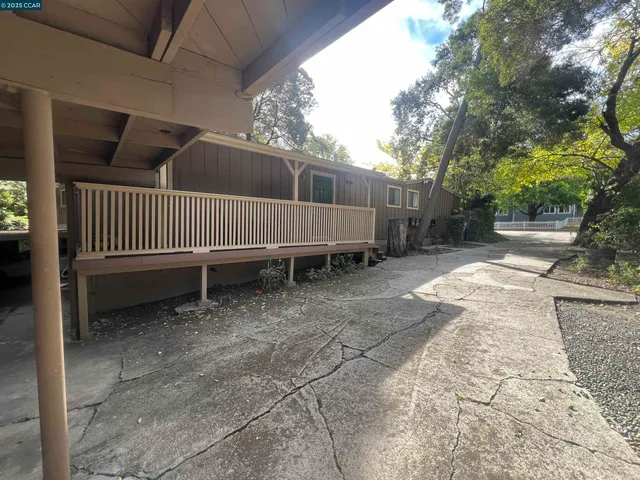 a view of balcony with wooden floor and seating space